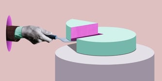 A hand holds a spatula and lifts a piece of cake from a whole cake. 