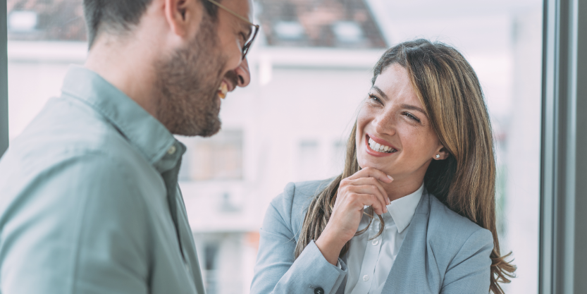 A woman smiles at a man.