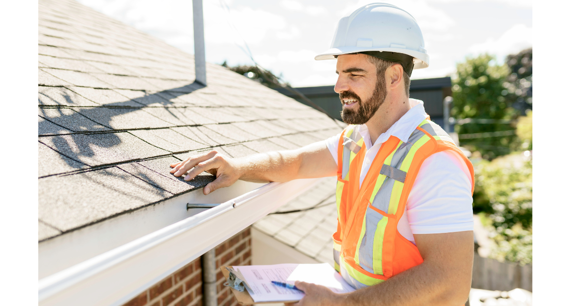 A professional inspects the shingles on a roof.