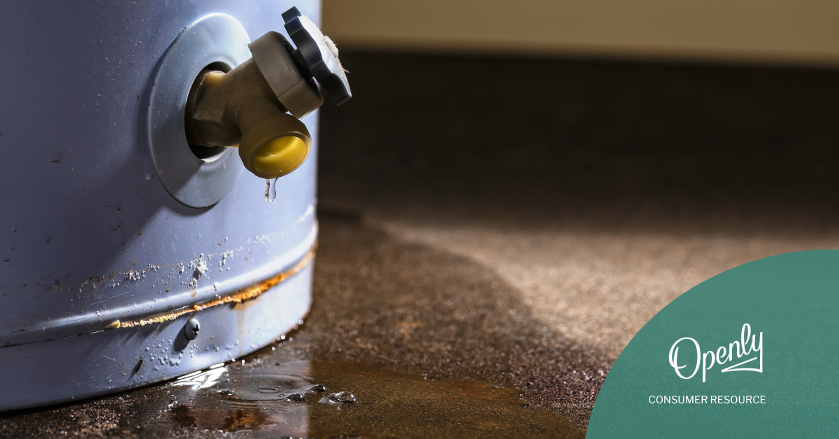 A water heater leaks onto a concrete floor.